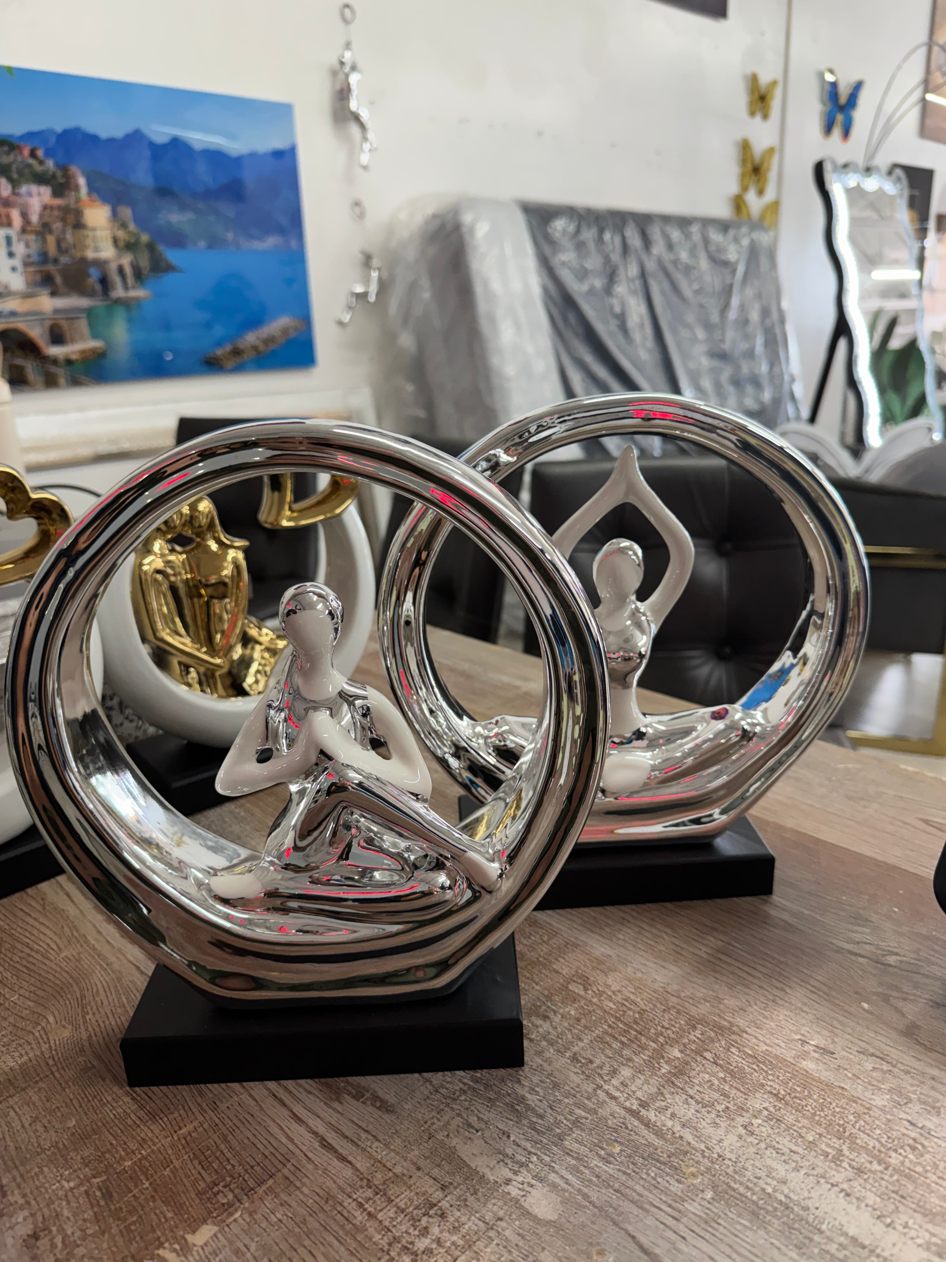 SILVER CHROME AND WHITE CERAMIC YOGA LADY SCULPTURE WITH A BLACK BASE