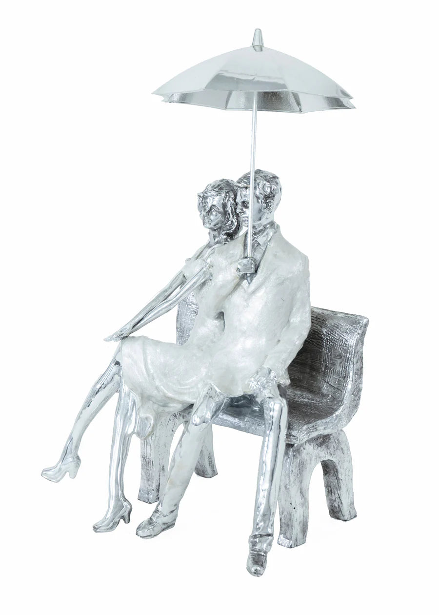 COUPLE ON BENCH WITH UMBRELLA SCULPTURE