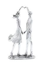 COUPLE FORMING A HEART SCULPTURE