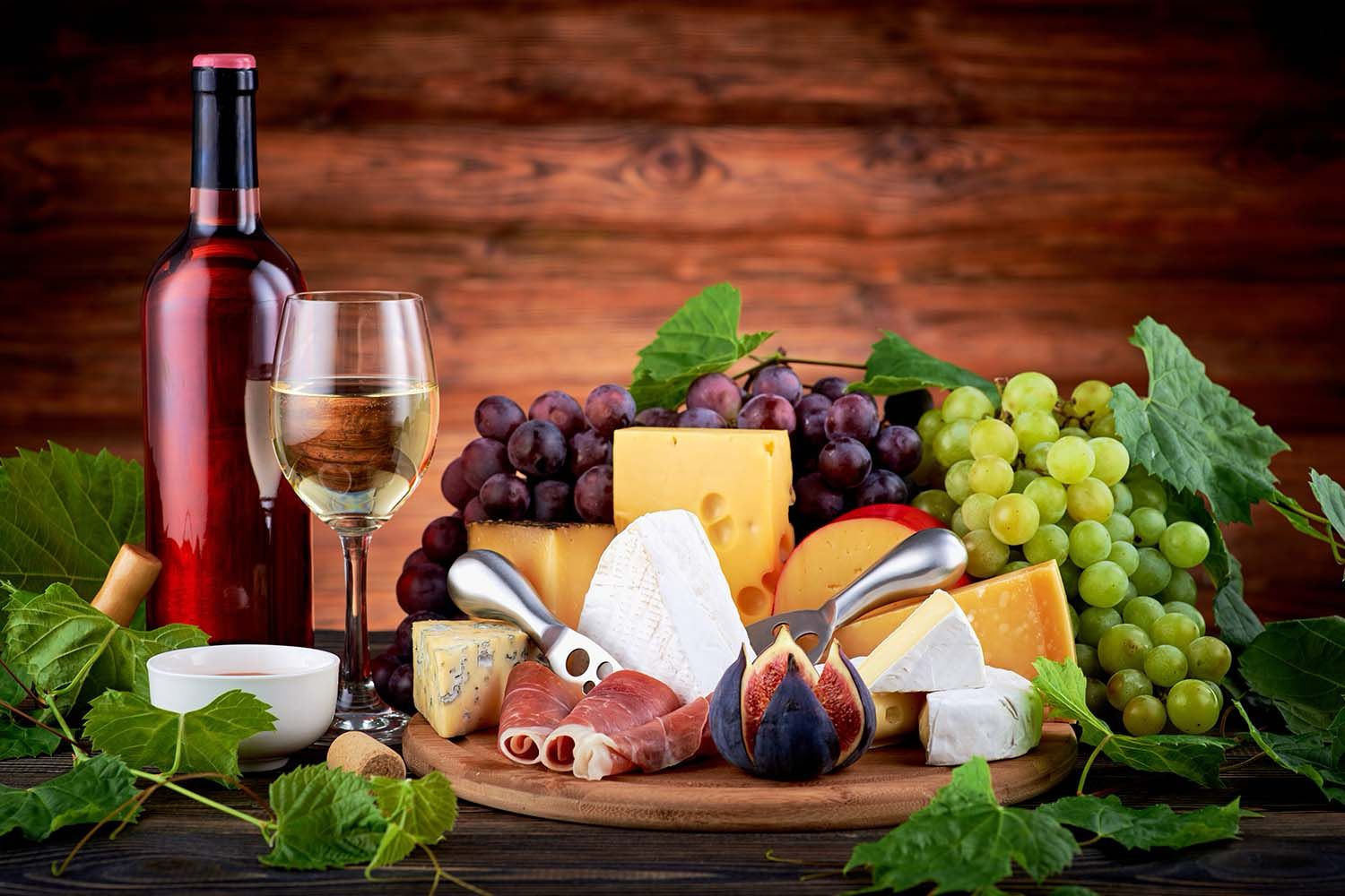 CHEESE BOARD AND WINE ON THE TABLE